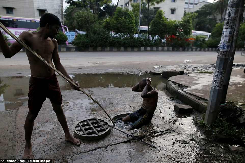 They are paid Â£7.50 a day at most to swim through the polluted sewers of the overpopulated capital of Dhaka